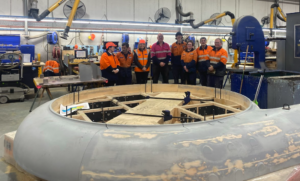 weir team gathered around machinery